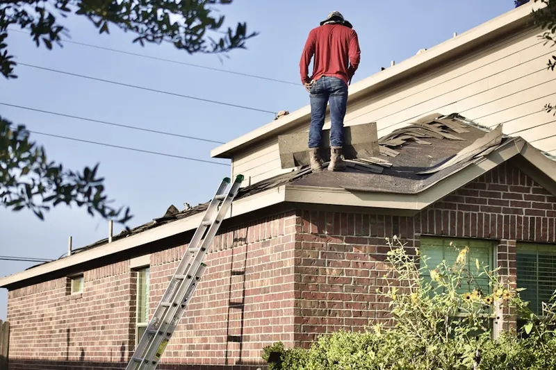 Professional roofer working on a residential roof in Montgomery Heights